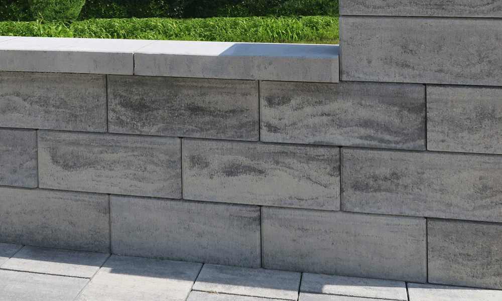 Múr z Nuavo plotového a múrového kameňa vo farbe žulovo sivá tieňovaná – štýlové riešenie od spoločnosti Friedl Steinwerke v modernej záhrade. Múr z Nuavo plotového a múrového kameňa vo farbe žulovo sivá tieňovaná – štýlové riešenie od spoločnosti Friedl Steinwerke v modernej záhrade.